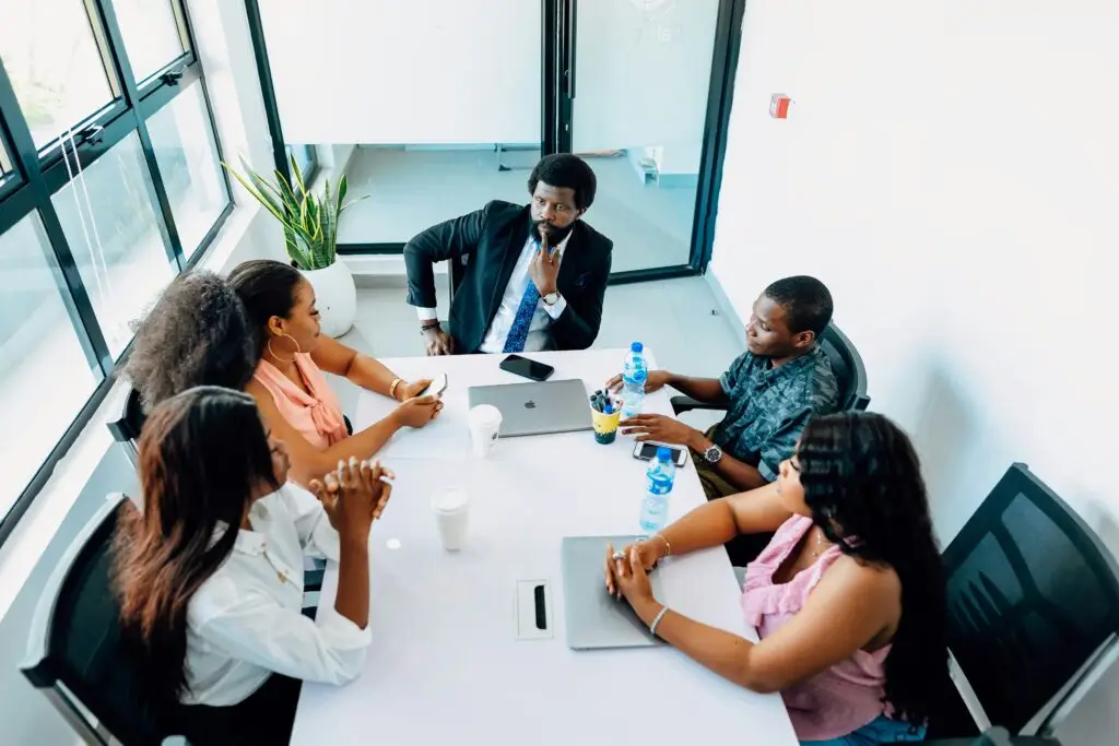 Colleagues in a professional meeting discussing administrative support strategies