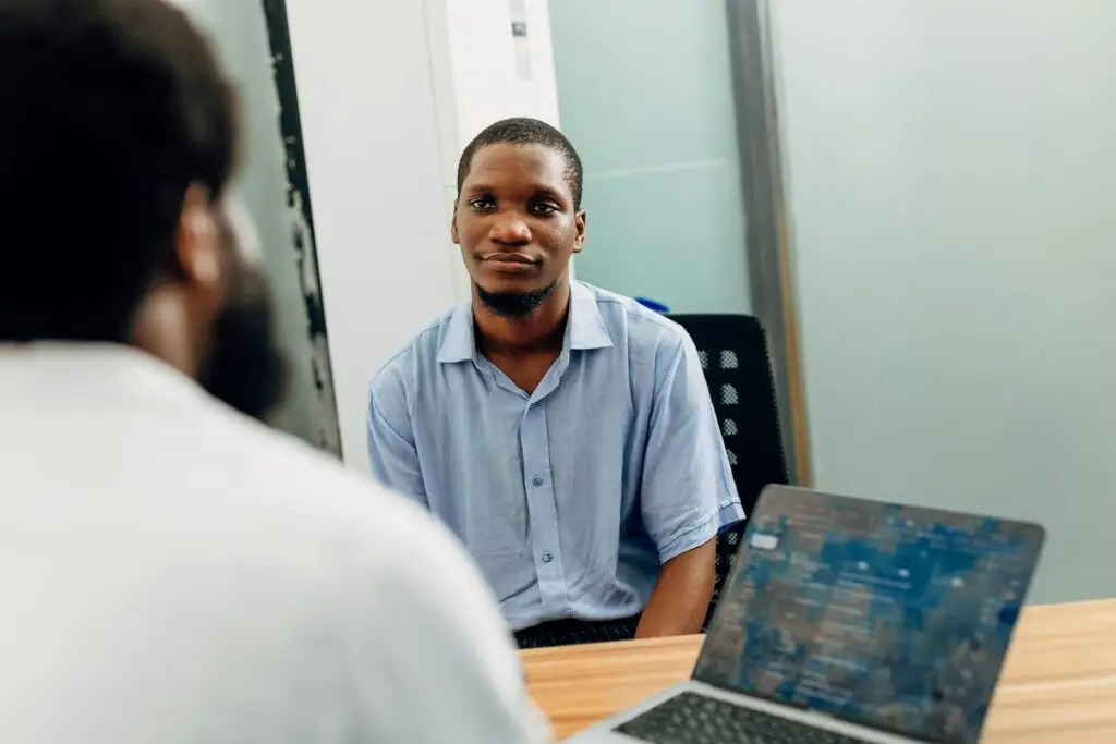 Man attentively listening during a recruitment consultation in a modern office
